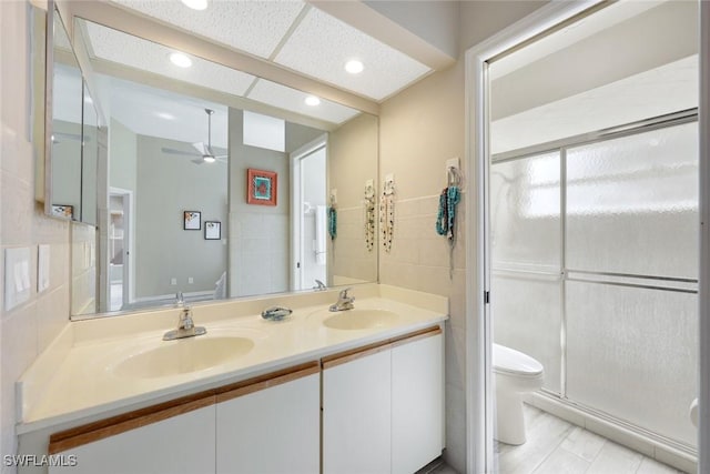 14871 Crescent Cove Dr, Fort Myers, FL 33908 - bathroom featuring double vanity, toilet, a shower stall, and a sink