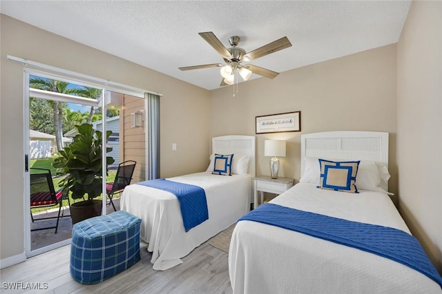 14871 Crescent Cove Dr, Fort Myers, FL 33908 - bedroom with ceiling fan, a textured ceiling, baseboards, light wood-style floors, and access to outside