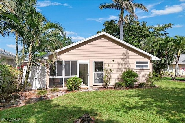 14871 Crescent Cove Dr, Fort Myers, FL 33908 - back of property featuring a sunroom and a yard