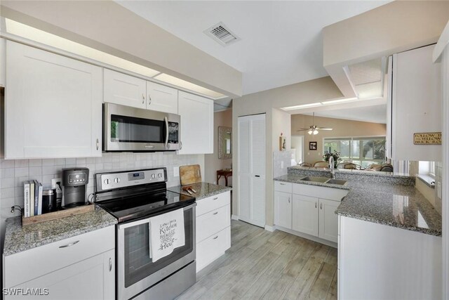 14871 Crescent Cove Dr, Fort Myers, FL 33908 - kitchen featuring a sink, appliances with stainless steel finishes, white cabinets, and visible vents