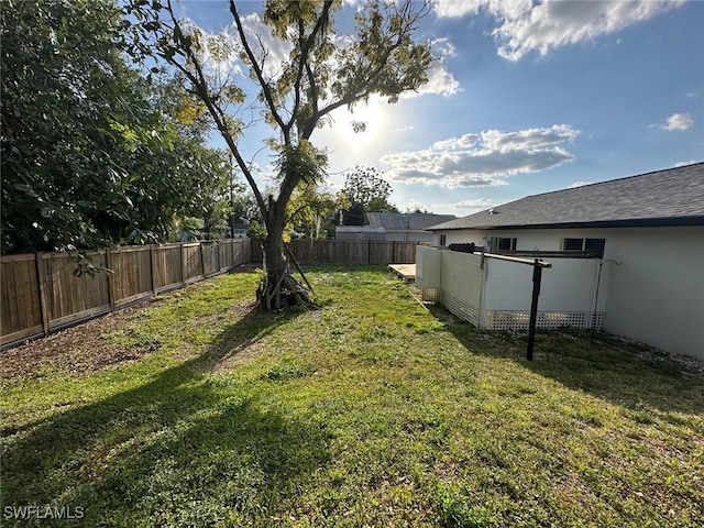 view of yard with a fenced backyard