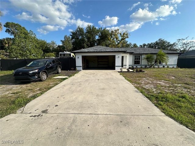 ranch-style home with concrete driveway, an attached garage, fence, and stucco siding