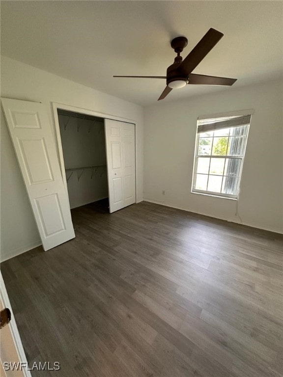 unfurnished bedroom with a closet, ceiling fan, and dark wood-style floors