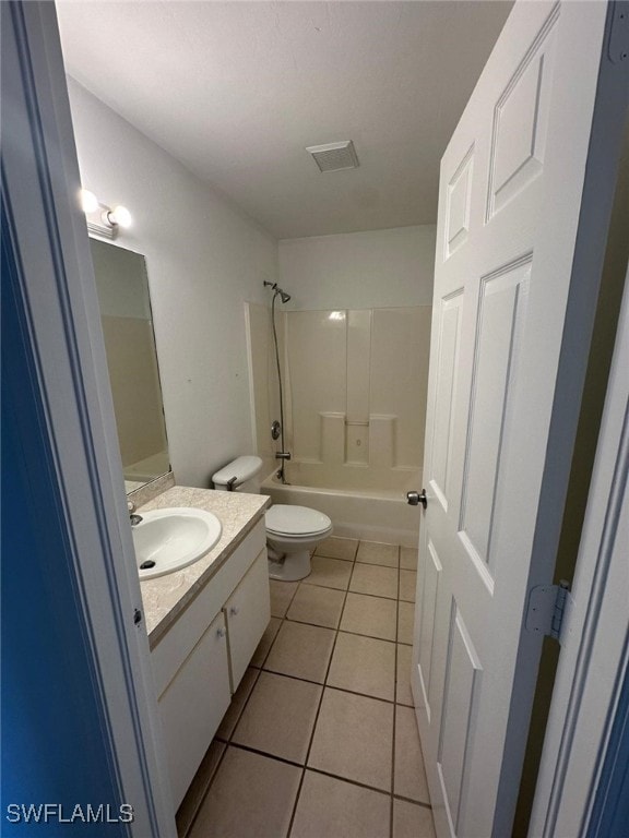 bathroom featuring toilet, bathtub / shower combination, tile patterned flooring, and vanity