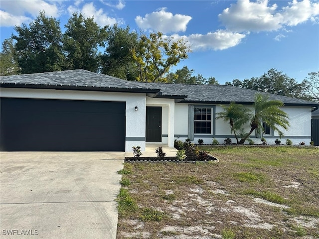 702 E 3rd St, Lehigh Acres, FL 33936 - view of front of house with concrete driveway, a garage, stucco siding, and a shingled roof