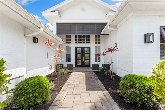 property entrance featuring french doors and stucco siding