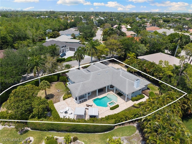 aerial view of property and surrounding area featuring property parcel outlined and a pool area