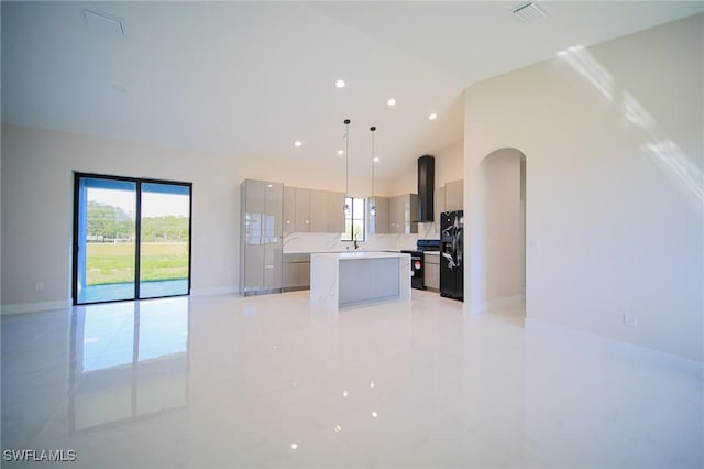 309 Fifth Ave, Lehigh Acres, FL 33936 - kitchen featuring black appliances, modern cabinets, a center island, extractor fan, and healthy amount of natural light