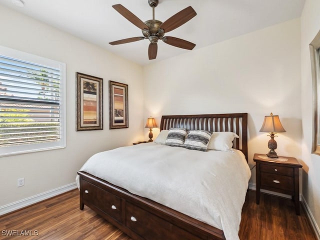 bedroom with a ceiling fan, wood finished floors, and baseboards