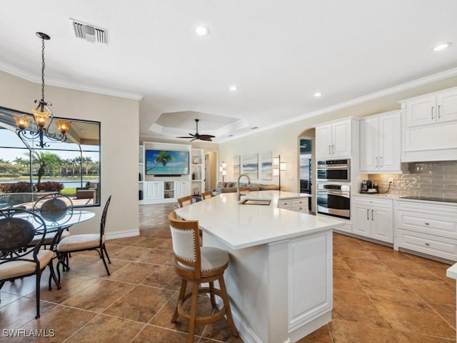 kitchen featuring tasteful backsplash, crown molding, a sink, visible vents, and stainless steel double oven