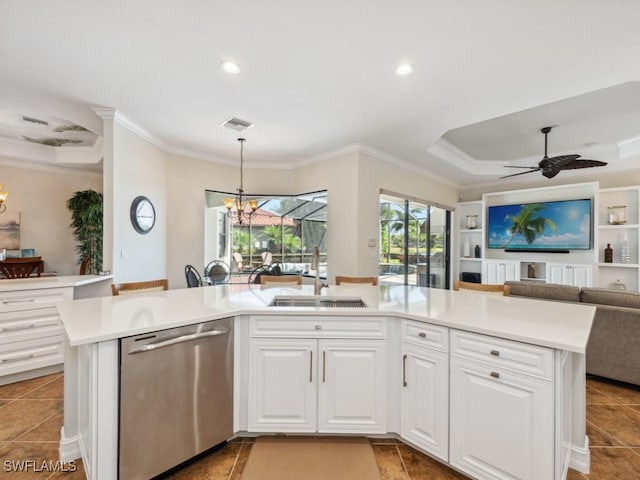 kitchen featuring light countertops, white cabinets, dishwasher, a sink, and open floor plan