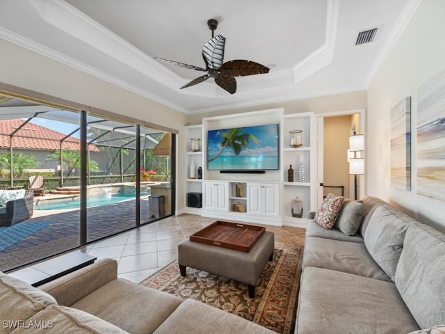 living area featuring crown molding, a sunroom, ceiling fan, and tile patterned floors