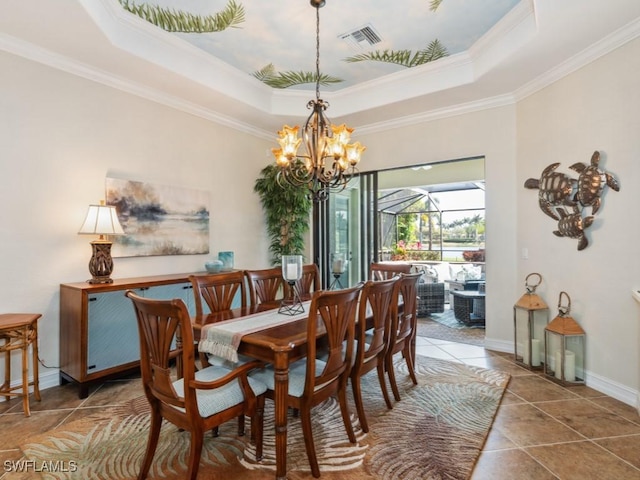 tiled dining area featuring an inviting chandelier, a tray ceiling, crown molding, visible vents, and baseboards