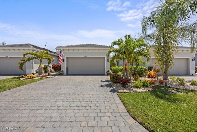 20005 Parrot Key Ct, Estero, FL 33928 - mediterranean / spanish home featuring stucco siding, a garage, and decorative driveway