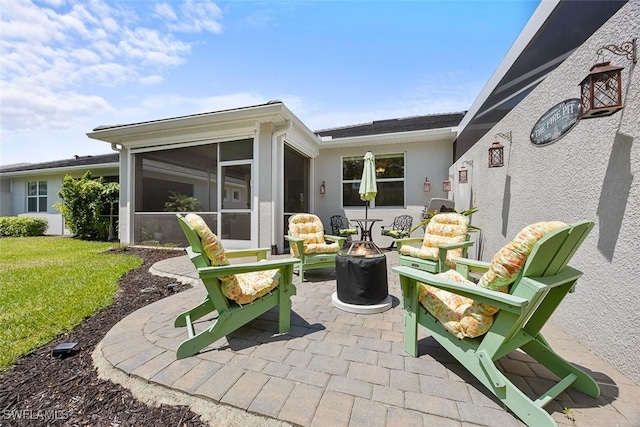 20005 Parrot Key Ct, Estero, FL 33928 - view of patio with a fire pit and a sunroom