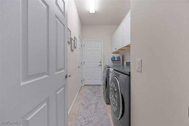 20005 Parrot Key Ct, Estero, FL 33928 - laundry area featuring separate washer and dryer, baseboards, and cabinet space