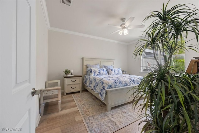 20005 Parrot Key Ct, Estero, FL 33928 - bedroom with ceiling fan, crown molding, light wood finished floors, and visible vents