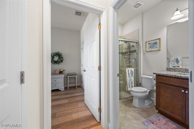 20005 Parrot Key Ct, Estero, FL 33928 - full bathroom with toilet, vanity, visible vents, and a stall shower