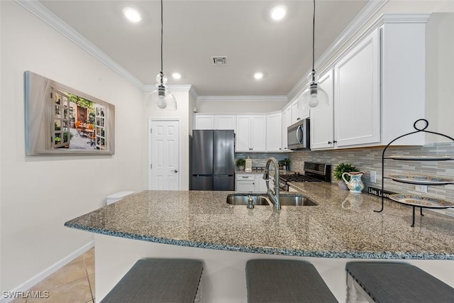 20005 Parrot Key Ct, Estero, FL 33928 - kitchen featuring visible vents, dark stone counters, stainless steel appliances, and a sink