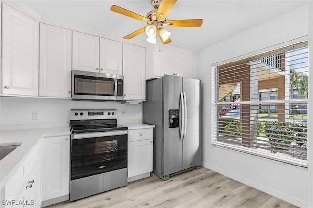 5731 Foxlake Dr Unit 1, North Fort Myers, FL 33917 - kitchen featuring light countertops, ceiling fan, appliances with stainless steel finishes, and white cabinetry