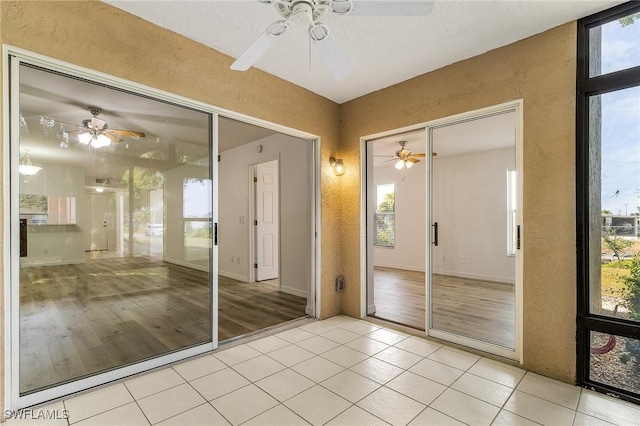 5731 Foxlake Dr Unit 1, North Fort Myers, FL 33917 - interior space featuring light tile patterned floors, ceiling fan, and a textured wall