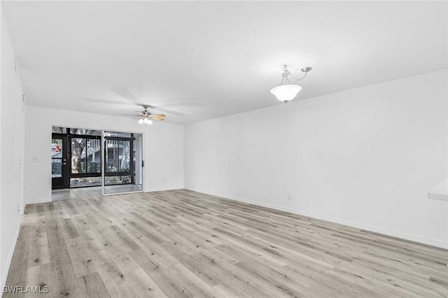 5731 Foxlake Dr Unit 1, North Fort Myers, FL 33917 - spare room featuring baseboards, ceiling fan, and light wood-style flooring