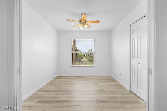 5731 Foxlake Dr Unit 1, North Fort Myers, FL 33917 - unfurnished bedroom featuring baseboards, a ceiling fan, light wood-style floors, and a closet