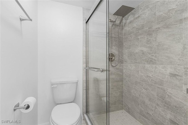 5731 Foxlake Dr Unit 1, North Fort Myers, FL 33917 - bathroom featuring baseboards, a stall shower, and toilet