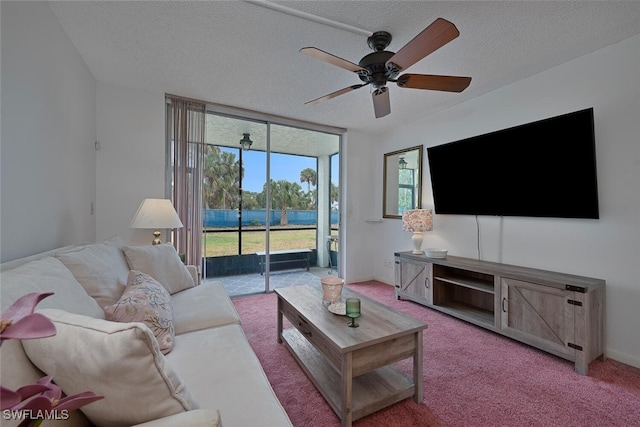 carpeted living room featuring a ceiling fan, a textured ceiling, and floor to ceiling windows