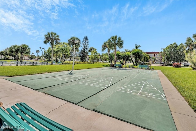 view of property's community featuring shuffleboard and a lawn