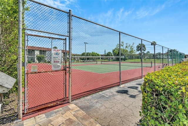 view of sport court featuring a gate and fence