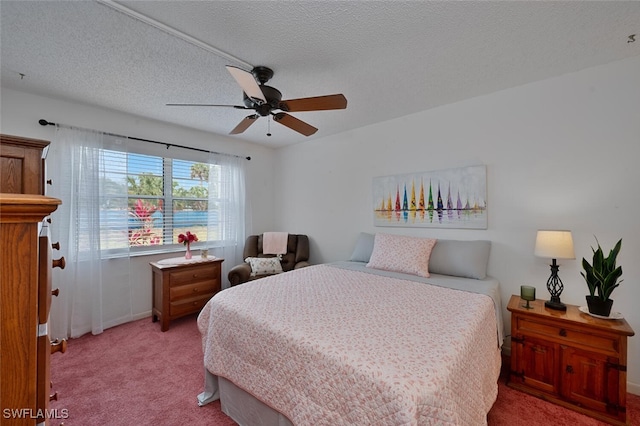 bedroom featuring light colored carpet, a textured ceiling, baseboards, and ceiling fan