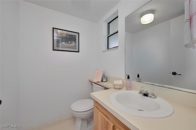 bathroom featuring tile patterned floors, toilet, and vanity