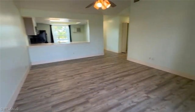 1521 SW 47th Ter Unit 204, Cape Coral, FL 33914 - spare room featuring wood finished floors, a ceiling fan, and baseboards