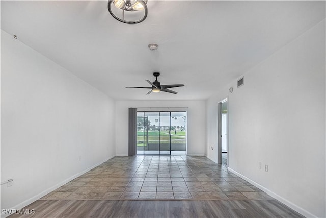 unfurnished room with ceiling fan, baseboards, and a smoke detector