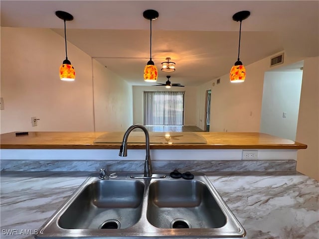2241 E 5th St Unit 103, Lehigh Acres, FL 33936 - kitchen with a sink and decorative light fixtures