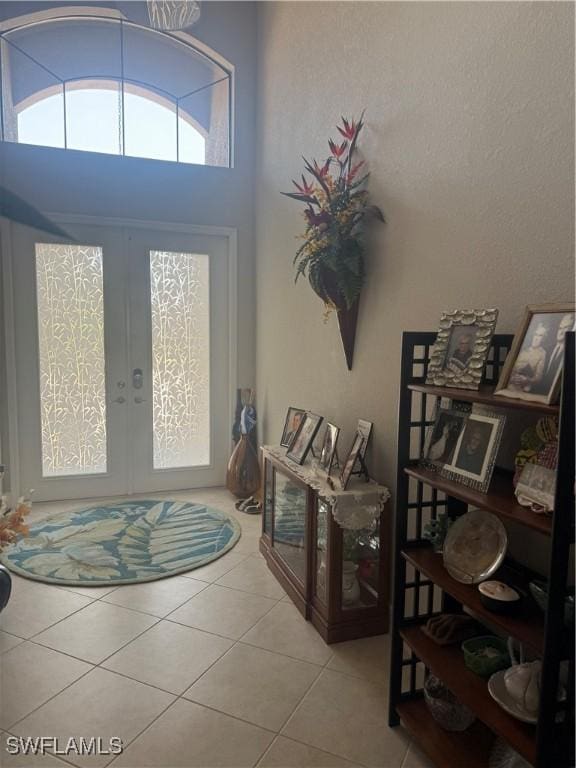 foyer with tile patterned flooring and french doors