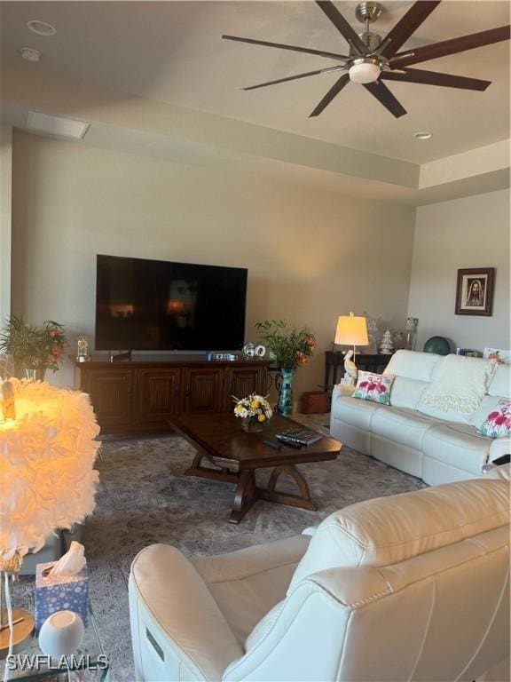 living area featuring a ceiling fan
