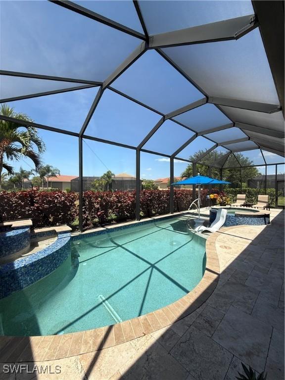 view of pool featuring a pool with connected hot tub and a patio area