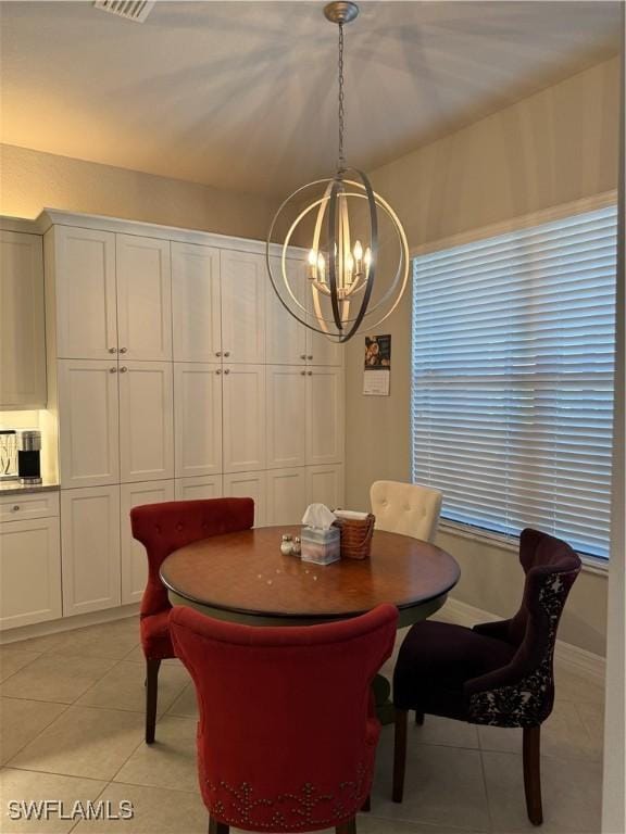 dining space featuring a chandelier and light tile patterned floors