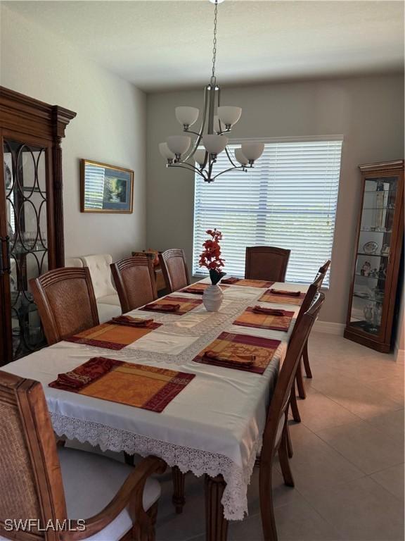 dining room with an inviting chandelier and light tile patterned flooring
