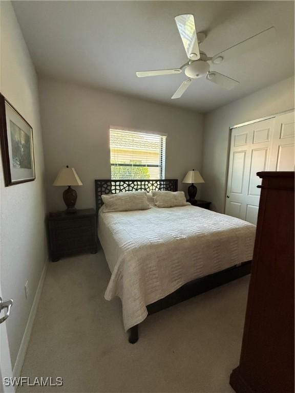 carpeted bedroom featuring a ceiling fan, baseboards, and a closet