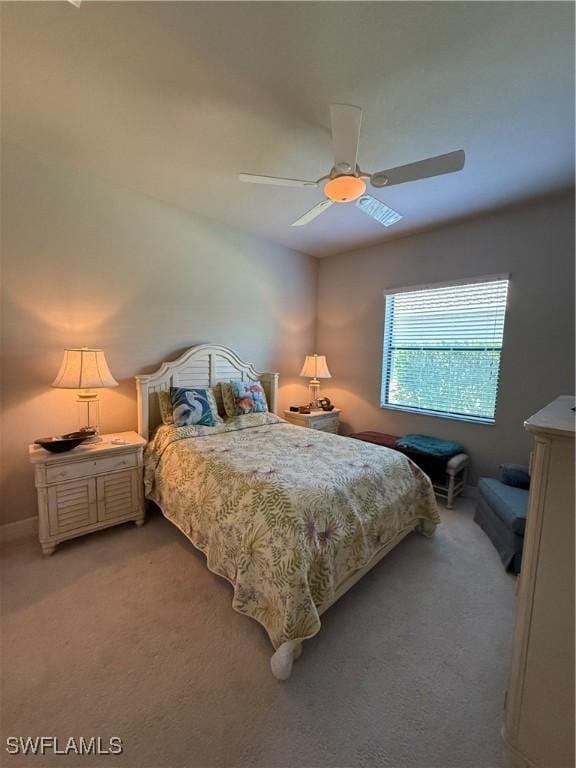 bedroom featuring ceiling fan and light carpet