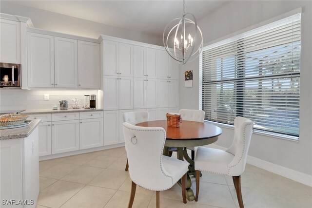 11692 Stonecreek Cir, Fort Myers, FL 33913 - dining space with a chandelier, plenty of natural light, and light tile patterned floors