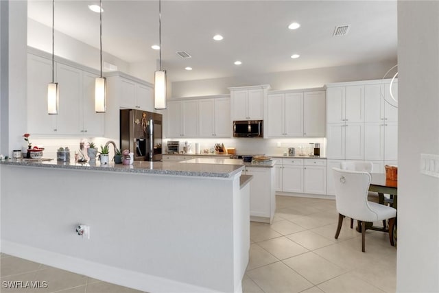 11692 Stonecreek Cir, Fort Myers, FL 33913 - kitchen with appliances with stainless steel finishes, a peninsula, white cabinetry, light tile patterned floors, and recessed lighting