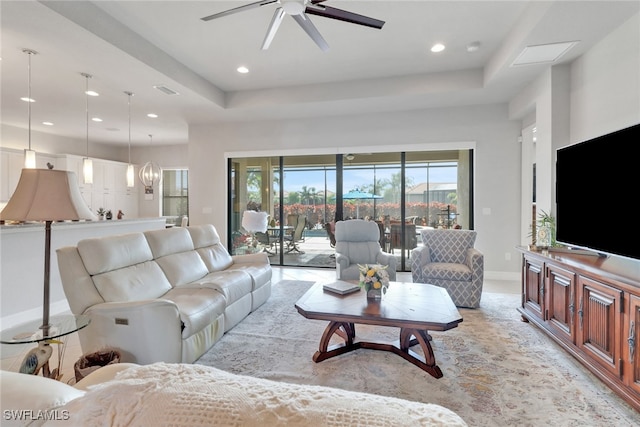 11692 Stonecreek Cir, Fort Myers, FL 33913 - living room with ceiling fan, recessed lighting, a tray ceiling, baseboards, and a chandelier