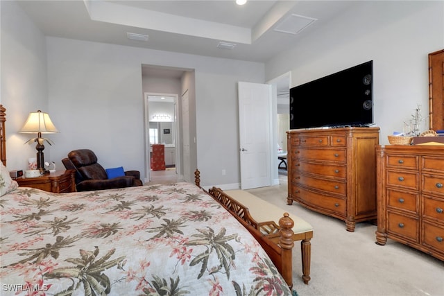 11692 Stonecreek Cir, Fort Myers, FL 33913 - bedroom featuring light colored carpet, a raised ceiling, and connected bathroom