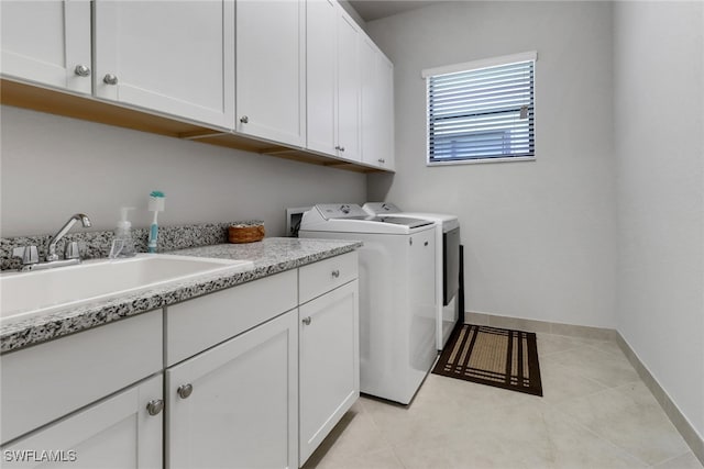11692 Stonecreek Cir, Fort Myers, FL 33913 - clothes washing area with cabinet space, separate washer and dryer, and baseboards