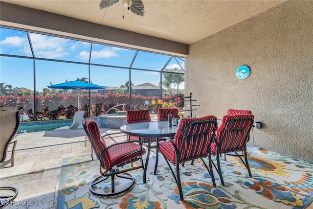11692 Stonecreek Cir, Fort Myers, FL 33913 - view of patio with a hot tub, ceiling fan, glass enclosure, and outdoor dining area