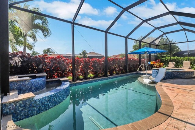 11692 Stonecreek Cir, Fort Myers, FL 33913 - view of pool with a pool with connected hot tub, a patio, and glass enclosure